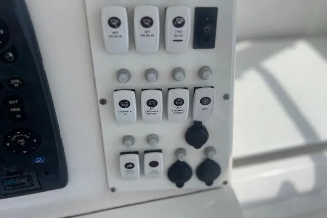 Slide: The Image of Control panel of a 2011 Everglades 350LX boat with labeled switches and buttons. - 17