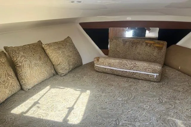 Slide: The Image of 2011 Everglades 350LX cabin interior with patterned cushions and bedding. - 27