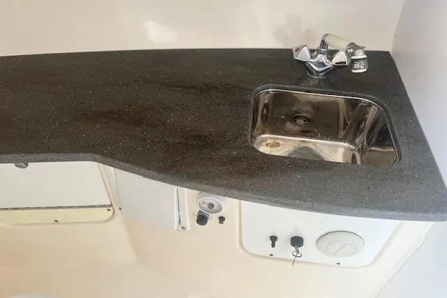 Slide: The Image of 2011 Everglades 350LX boat interior with sink and countertop. - 28