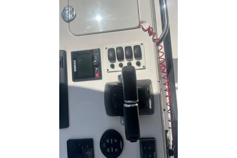 Slide: The Image of Control panel of a 2011 Everglades 350LX boat with switches and throttle. - 30