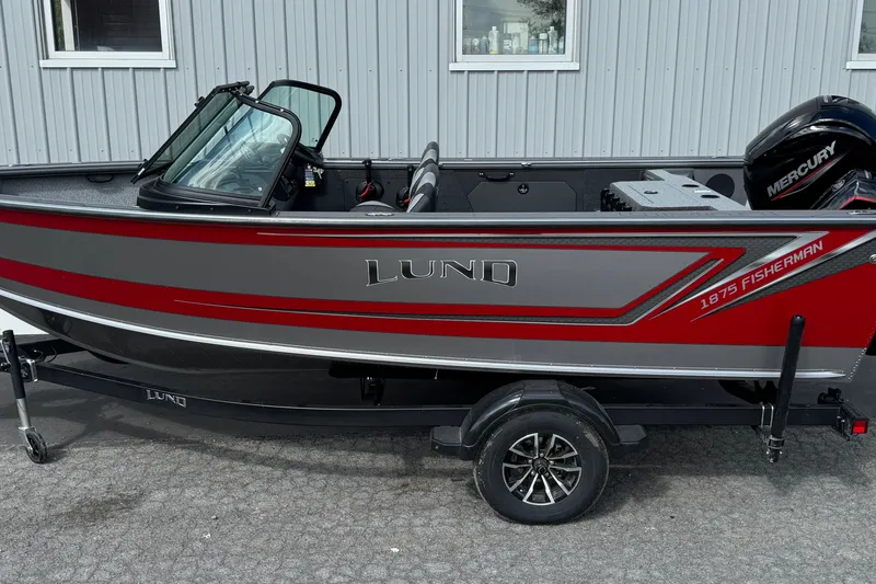 The Image of 2026 Lund 1875 Fisherman boat with Mercury engine, parked on trailer. - 0