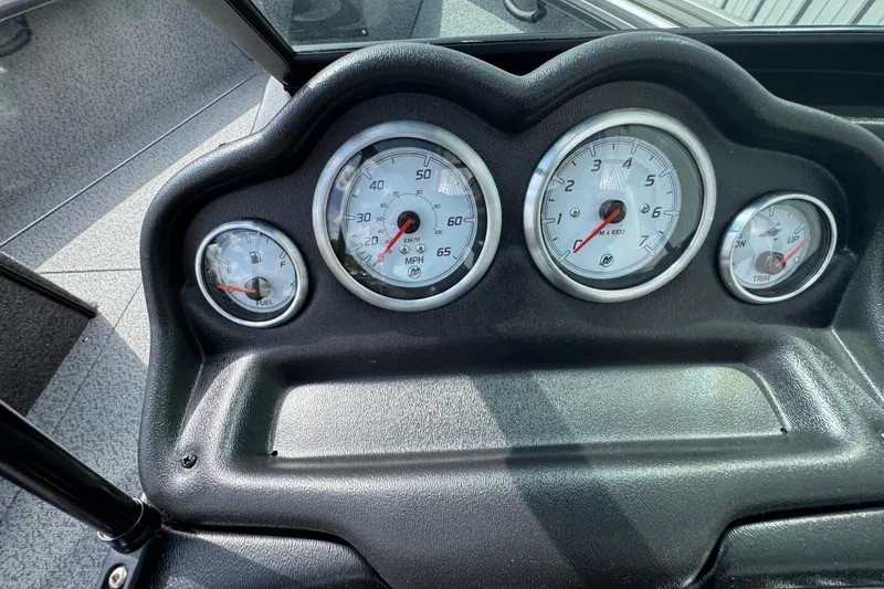 Slide: The Image of 2026 Lund 1875 Fisherman dashboard with speedometer, tachometer, fuel, and trim gauges. - 11