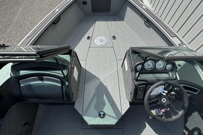 Slide: The Image of 2026 Lund 1875 Fisherman boat interior with dual consoles and steering wheel. - 3