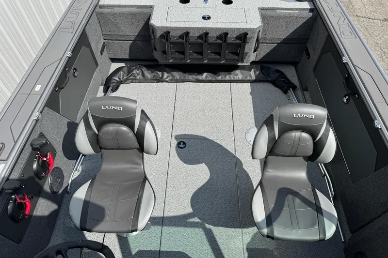 Slide: The Image of 2026 Lund 1875 Fisherman boat interior with two seats and storage compartments. - 6