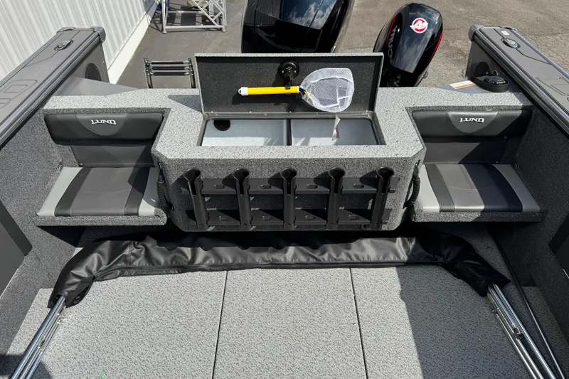 Slide: The Image of 2026 Lund 1875 Fisherman boat interior with seating, storage, and fishing rod holders. - 8