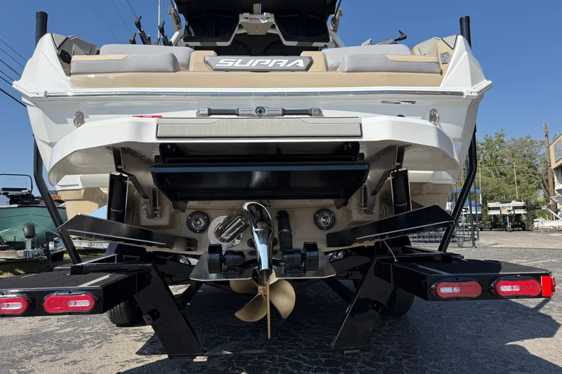 Slide: The Image of 2026 Supra SL 450 boat rear view with propeller and trailer. - 11