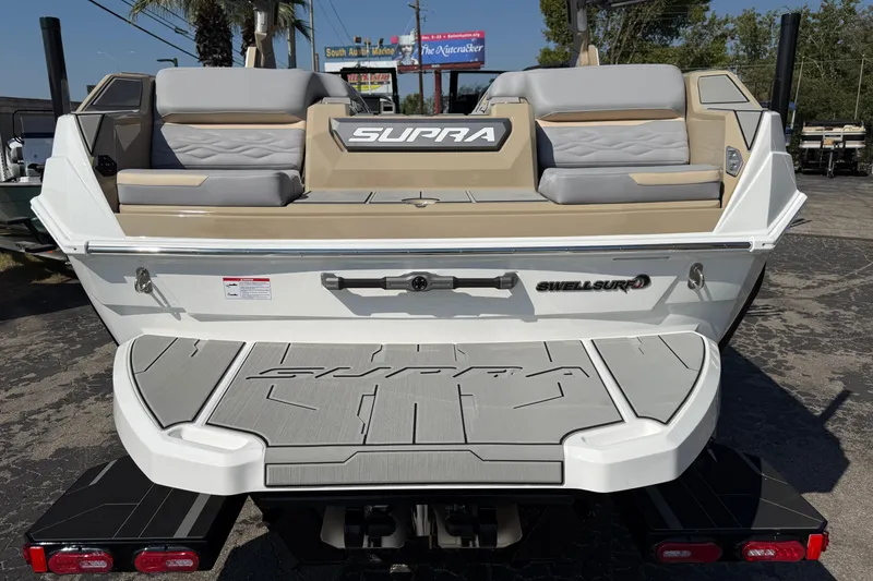 Slide: The Image of 2026 Supra SL 450 boat rear view with seating and SwellSurf technology. - 13