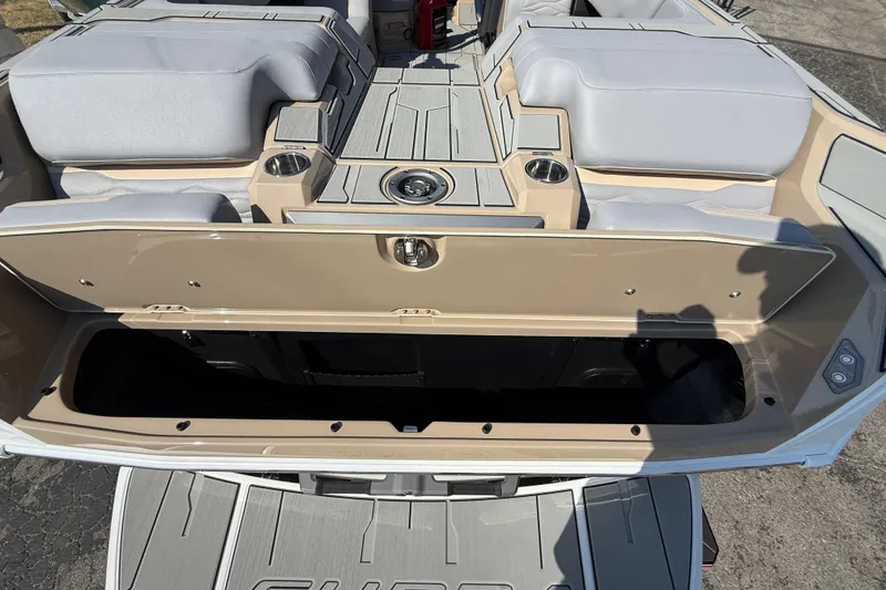 Slide: The Image of 2026 Supra SL 450 boat interior with open storage compartment and cushioned seating. - 17