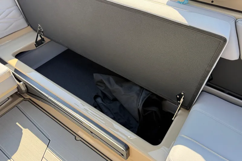 Slide: The Image of Open storage compartment in 2026 Supra SL 450 boat, showcasing interior space. - 34