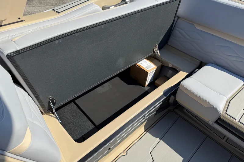Slide: The Image of 2026 Supra SL 450 interior storage compartment with beige and gray seating. - 39