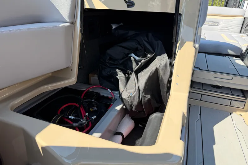 Slide: The Image of 2026 Supra SL 450 storage compartment with battery and cables visible. - 46