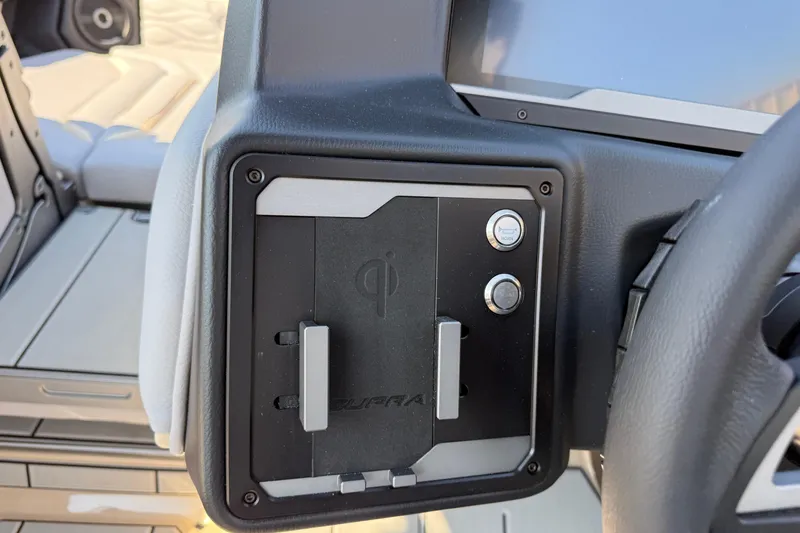 Slide: The Image of 2026 Supra SL 450 dashboard with wireless charging pad and control buttons. - 58