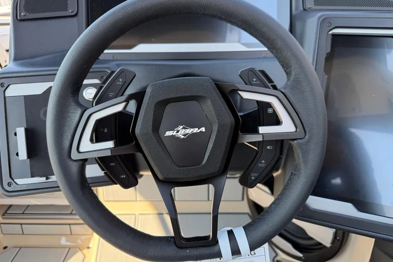 Slide: The Image of Steering wheel of 2026 Supra SL 450 with modern controls and dashboard display. - 59