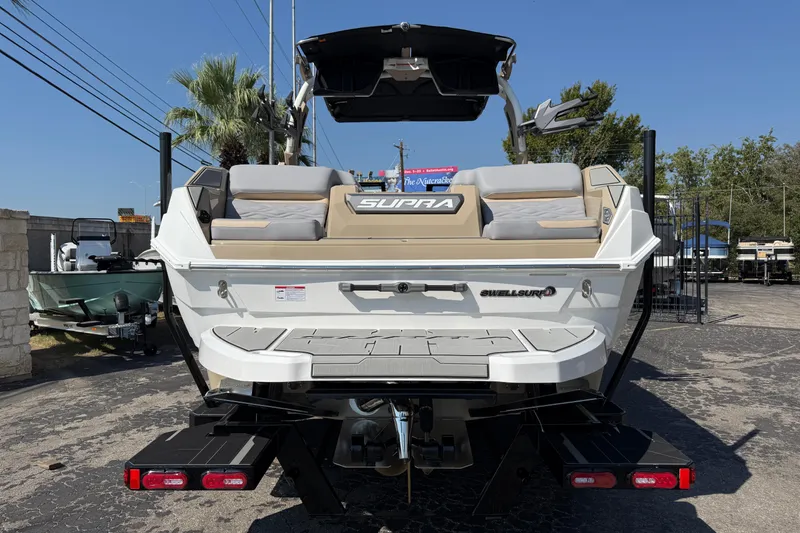 Slide: The Image of 2026 Supra SL 450 boat rear view, showcasing sleek design and spacious seating. - 6