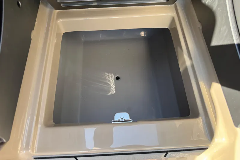 Slide: The Image of 2026 Supra SL 450 storage compartment, beige interior, open lid, sunlight reflection. - 67