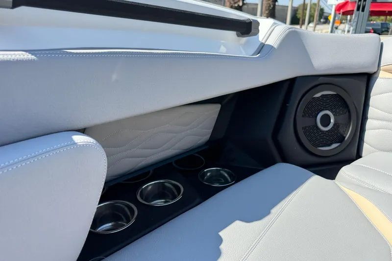 Slide: The Image of 2026 Supra SL 450 interior with speaker and cup holders, featuring sleek design and stitching. - 73