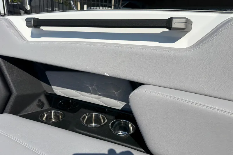 Slide: The Image of 2026 Supra SL 450 interior with sleek gray upholstery and built-in cup holders. - 74