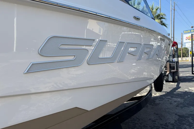 Slide: The Image of 2026 Supra SL 450 boat with sleek design and bold branding. - 9