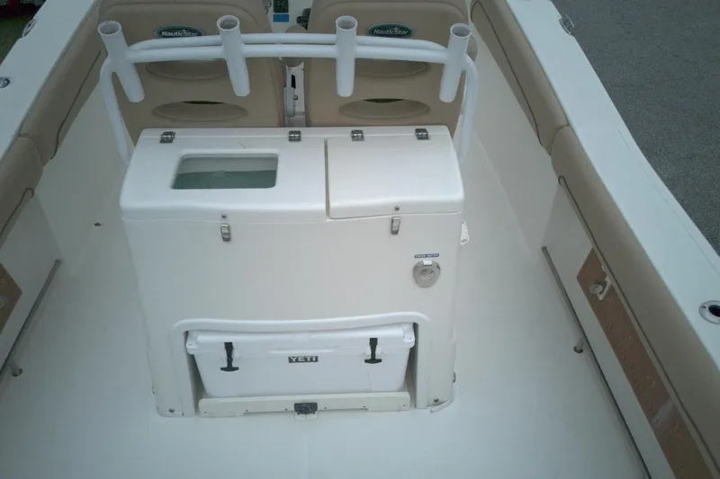 Slide: The Image of 2019 NauticStar 28 XS boat interior with seating and storage compartments. - 10