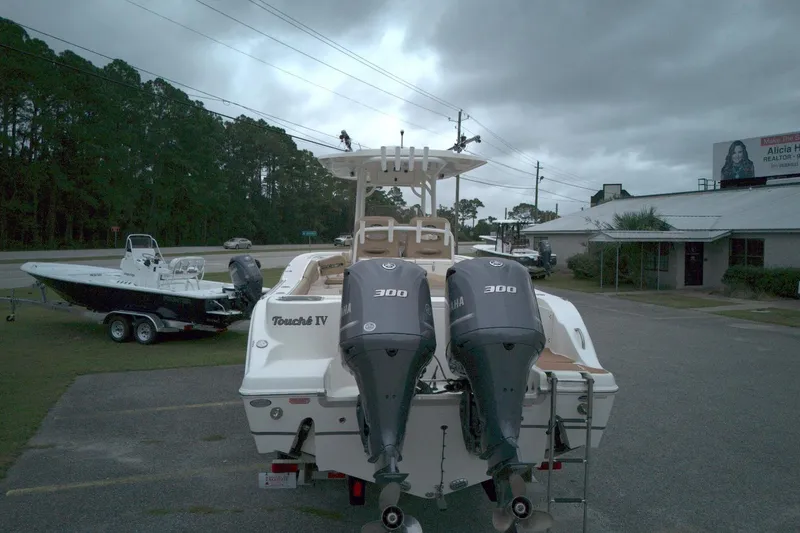 Slide: The Image of 2019 NauticStar 28 XS boat with dual Yamaha 300 engines, parked outdoors. - 3