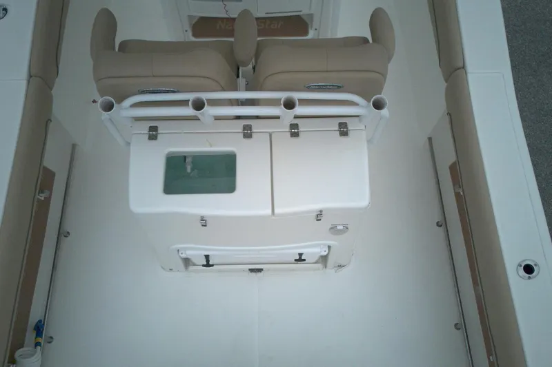 Slide: The Image of 2019 NauticStar 28 XS boat interior with seating and storage compartments. - 9