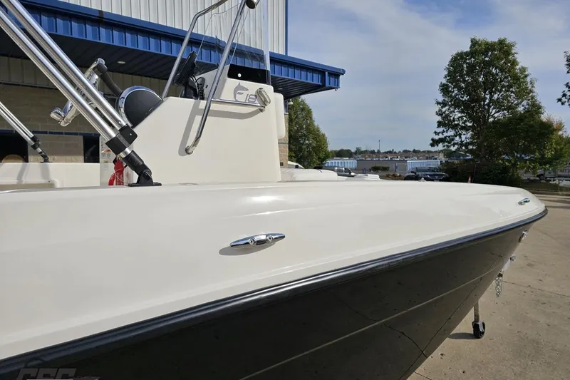 Slide: The Image of 2016 Bayliner Element F18 boat docked near a building, showcasing sleek design. - 10