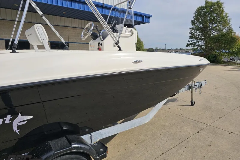 Slide: The Image of 2016 Bayliner Element F18 boat on trailer, parked outdoors near a building. - 11