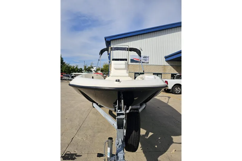 Slide: The Image of 2016 Bayliner Element F18 boat on trailer outside a building. - 19