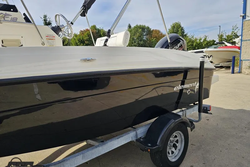 Slide: The Image of 2016 Bayliner Element F18 boat on trailer, parked outdoors. - 30