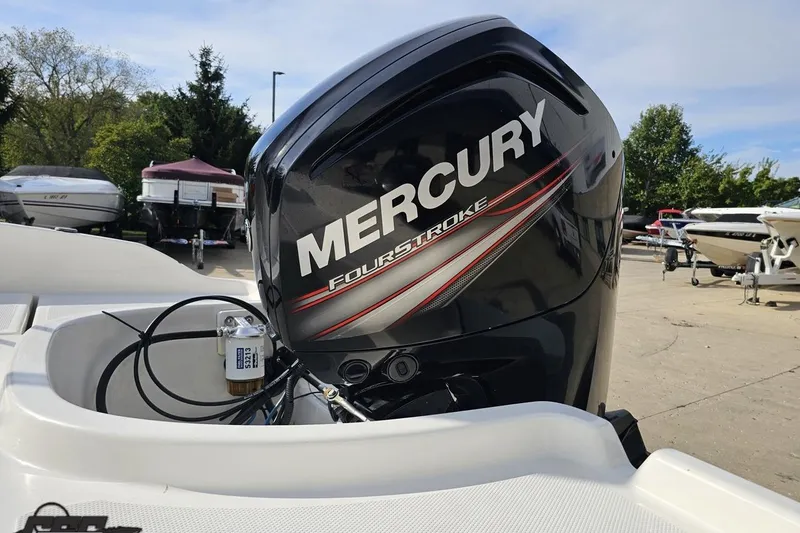 Slide: The Image of 2016 Bayliner Element F18 with Mercury FourStroke engine in a boatyard setting. - 36