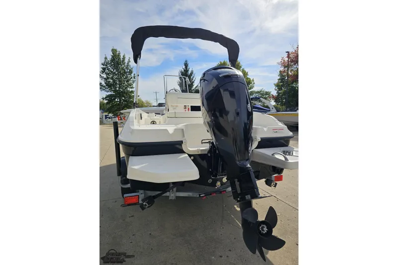 Slide: The Image of 2016 Bayliner Element F18 boat with outboard motor, parked on a trailer. - 40