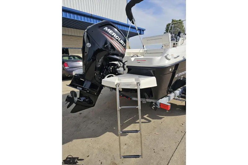 Slide: The Image of 2016 Bayliner Element F18 boat with Mercury outboard motor and ladder. - 44
