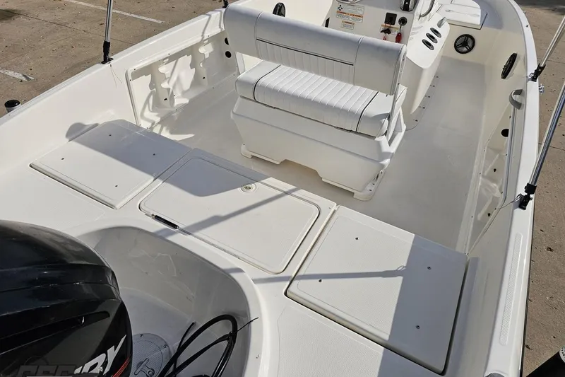 Slide: The Image of 2016 Bayliner Element F18 boat interior with seating and storage compartments. - 48