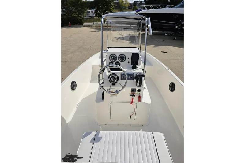 Slide: The Image of 2016 Bayliner Element F18 boat interior with steering console and seating. - 52