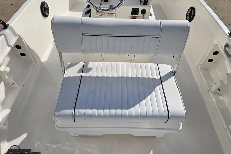 Slide: The Image of 2016 Bayliner Element F18 boat interior with white cushioned seating. - 53
