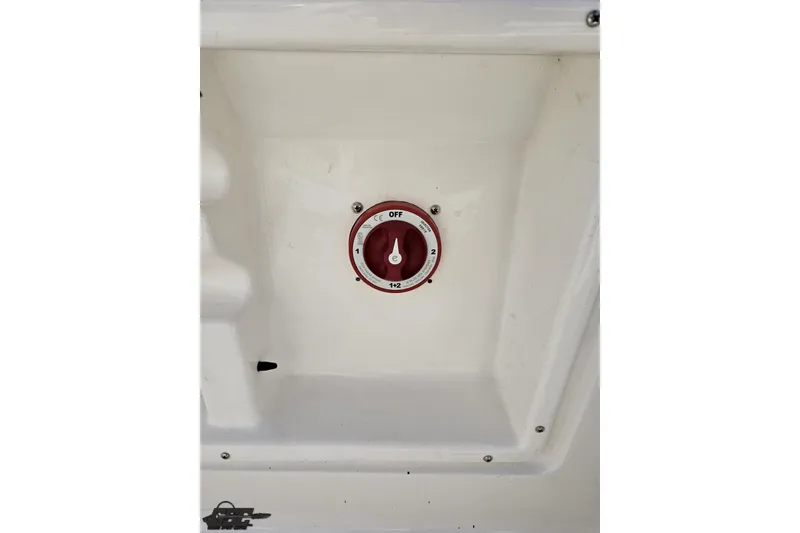 Slide: The Image of 2016 Bayliner Element F18 battery switch in white compartment. - 56