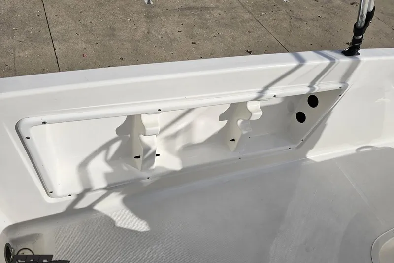 Slide: The Image of 2016 Bayliner Element F18 boat interior detail with rod holders and storage compartment. - 57
