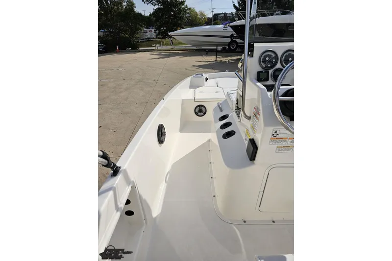 Slide: The Image of 2016 Bayliner Element F18 boat interior with steering console and seating area. - 58