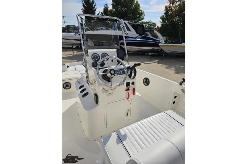 Slide: The Image of 2016 Bayliner Element F18 boat interior with steering wheel and control panel. - 59