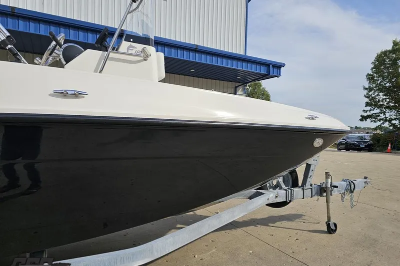 Slide: The Image of 2016 Bayliner Element F18 boat on trailer near a blue-roofed building. - 6