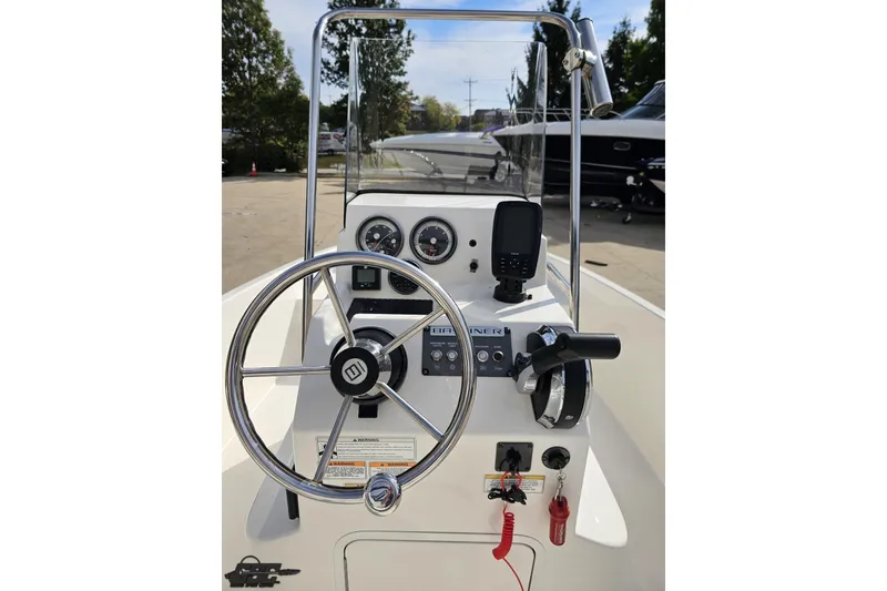 Slide: The Image of 2016 Bayliner Element F18 boat dashboard with steering wheel and controls. - 60