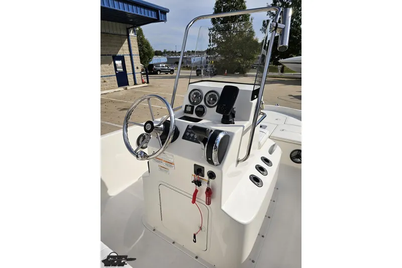 Slide: The Image of 2016 Bayliner Element F18 boat console with steering wheel and gauges. - 63