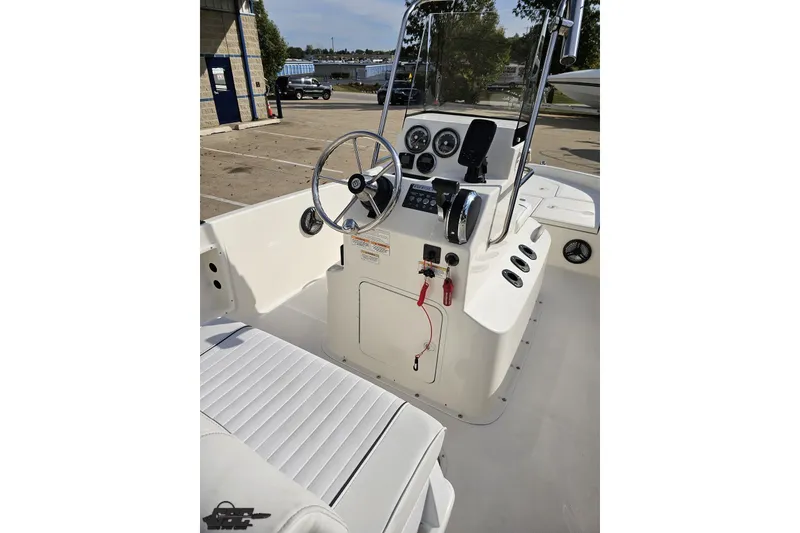 Slide: The Image of 2016 Bayliner Element F18 boat interior with steering wheel and control panel. - 64