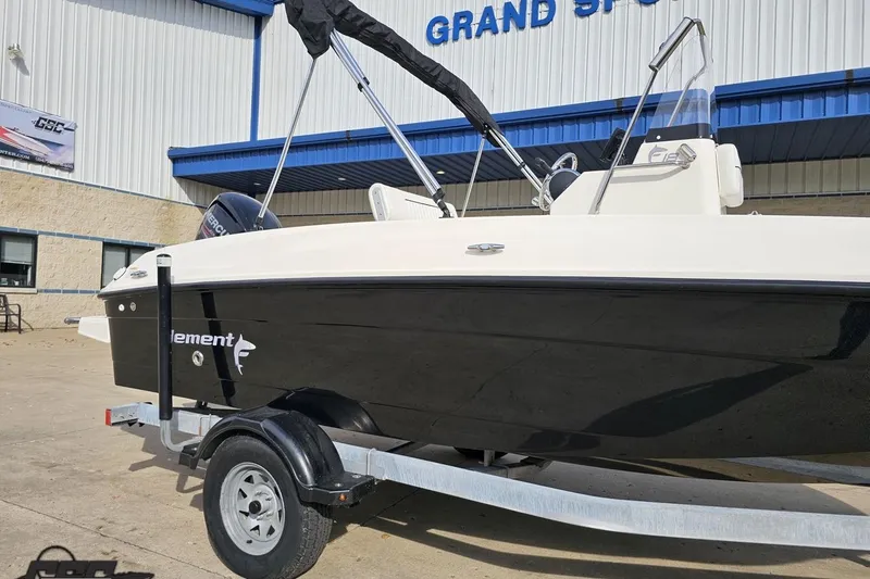 Slide: The Image of 2016 Bayliner Element F18 boat on trailer outside dealership. - 7
