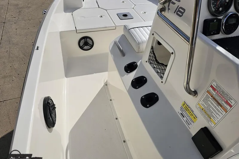 Slide: The Image of 2016 Bayliner Element F18 boat interior with seating and control panel details. - 70