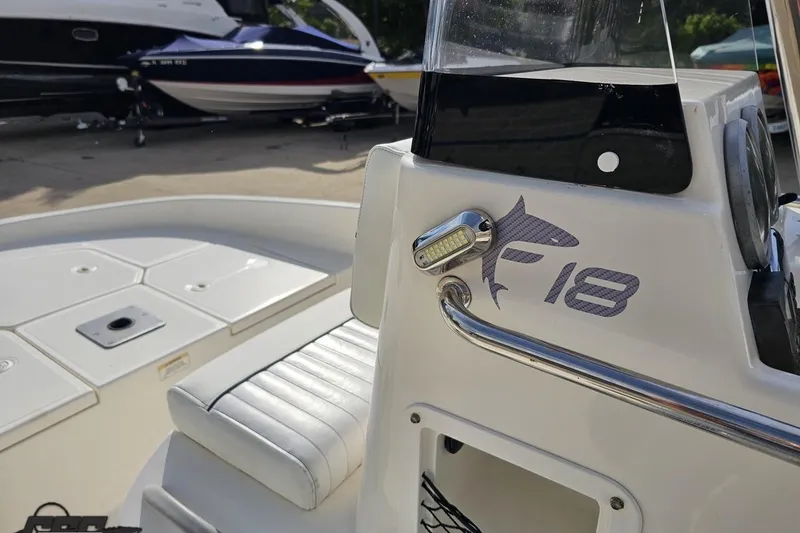 Slide: The Image of 2016 Bayliner Element F18 boat interior with logo and seating detail. - 72