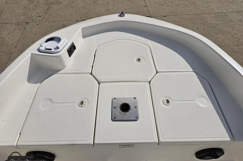 Slide: The Image of 2016 Bayliner Element F18 boat deck with storage compartments and cup holder. - 76