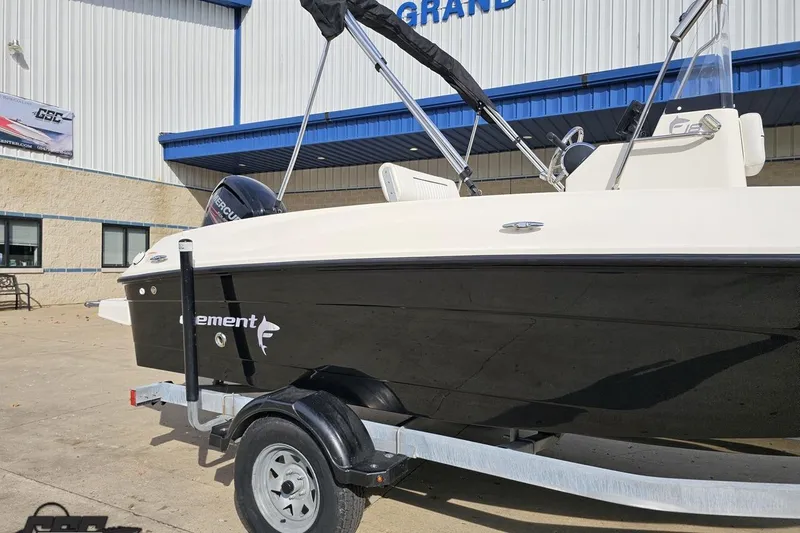 Slide: The Image of 2016 Bayliner Element F18 boat on trailer outside a building. - 8