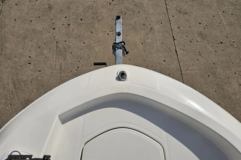 Slide: The Image of Bow of 2016 Bayliner Element F18 boat on a trailer, concrete background. - 81