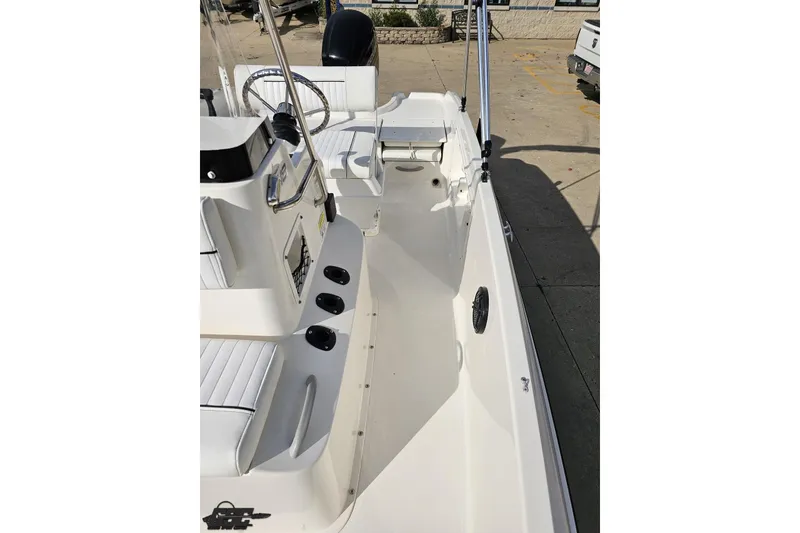 Slide: The Image of 2016 Bayliner Element F18 boat interior with seating and steering wheel. - 85